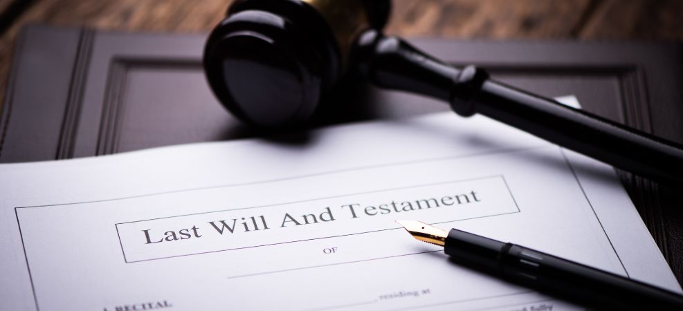 Last will and testament paperwork on a desk with a pen and gavel